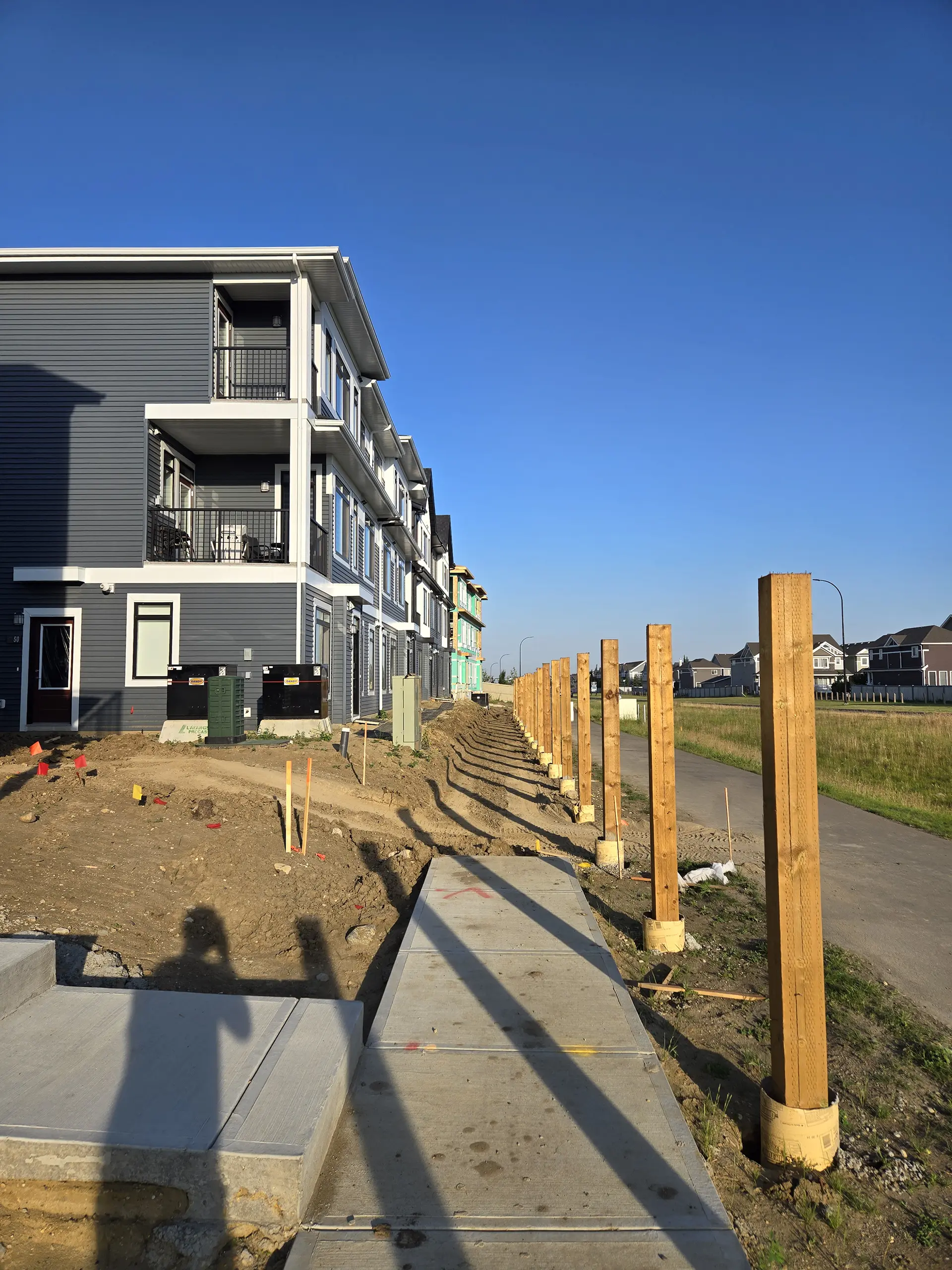 Pressure treated fence post set in concrete — Edmonton fence installation